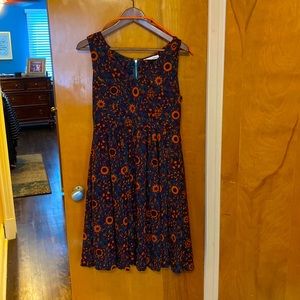 Moon Meadow boutique dress in green with orange and burgundy flower print